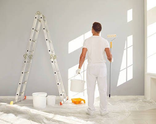 Habitación en preparación, con escalera y materiales de pintura.